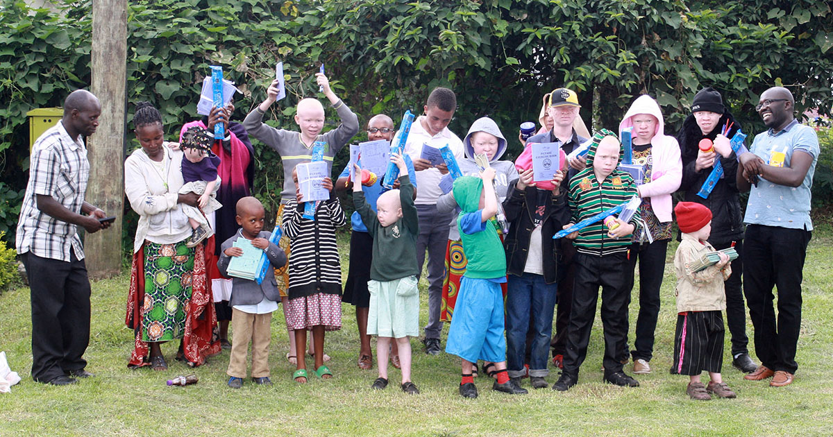 child sponsorship children with albinism in Kisoro district after receiving scholastic items